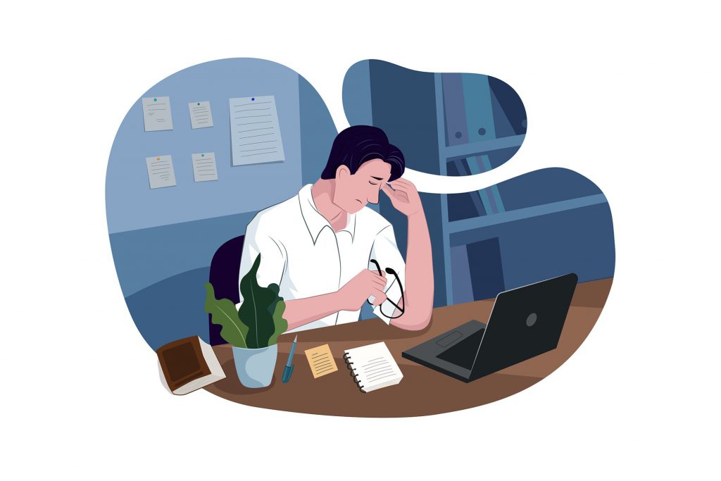 Illustration of a man looking disappointed while working at a desk. Success factors for small business include choosing a well though out business model.