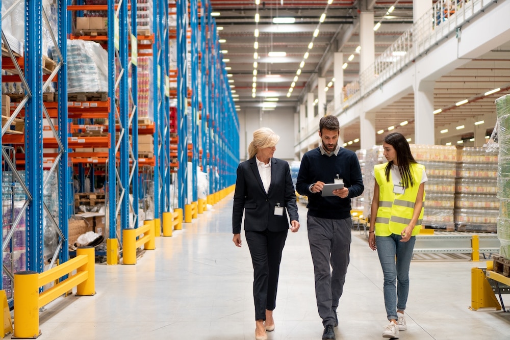 Photo of manufacturing company employees walking through a warehouse